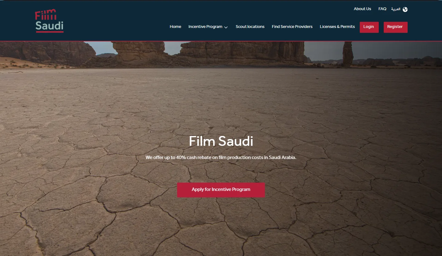 The Film Saudi website home page hero: the header, the headline, the cash rebate line and the Apply button over a photo of cracked desert ground